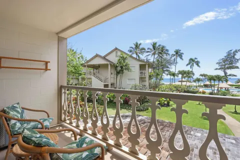 Balcony with chairs overlooking gardens and ocean at Aston Islander on the Beach.