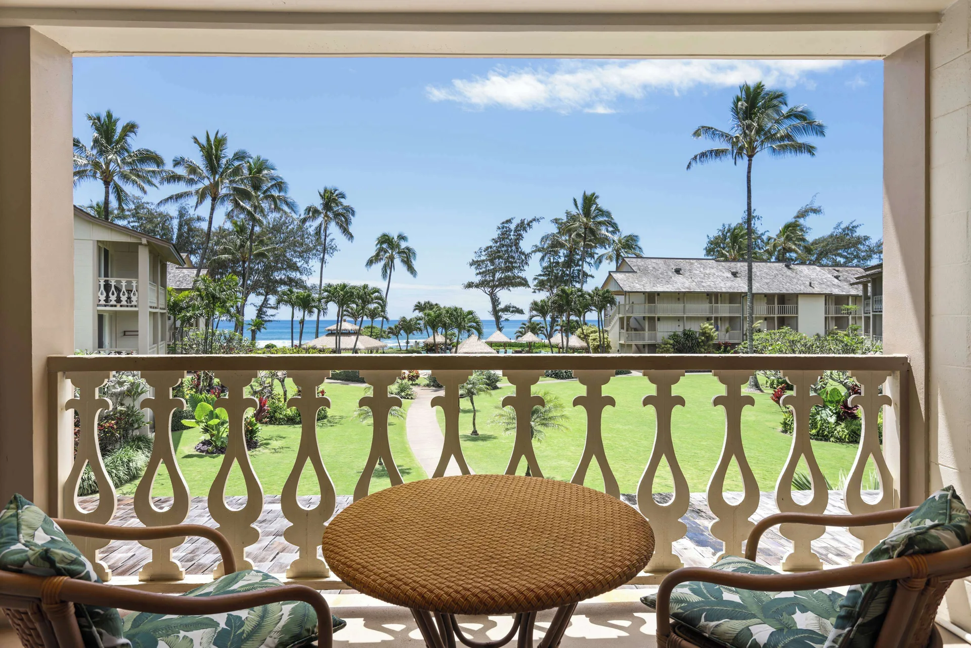Balcony seating with garden and ocean view at Aston Islander on the Beach.