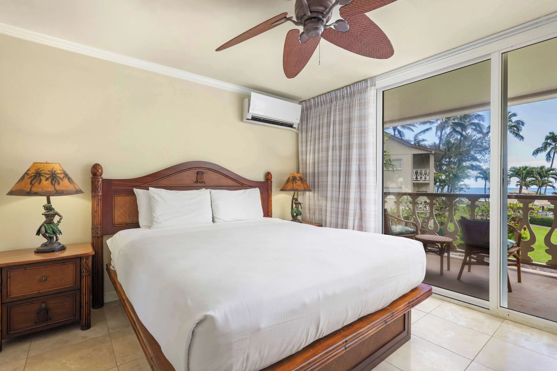 Guest room with king bed and balcony view at Aston Islander on the Beach.