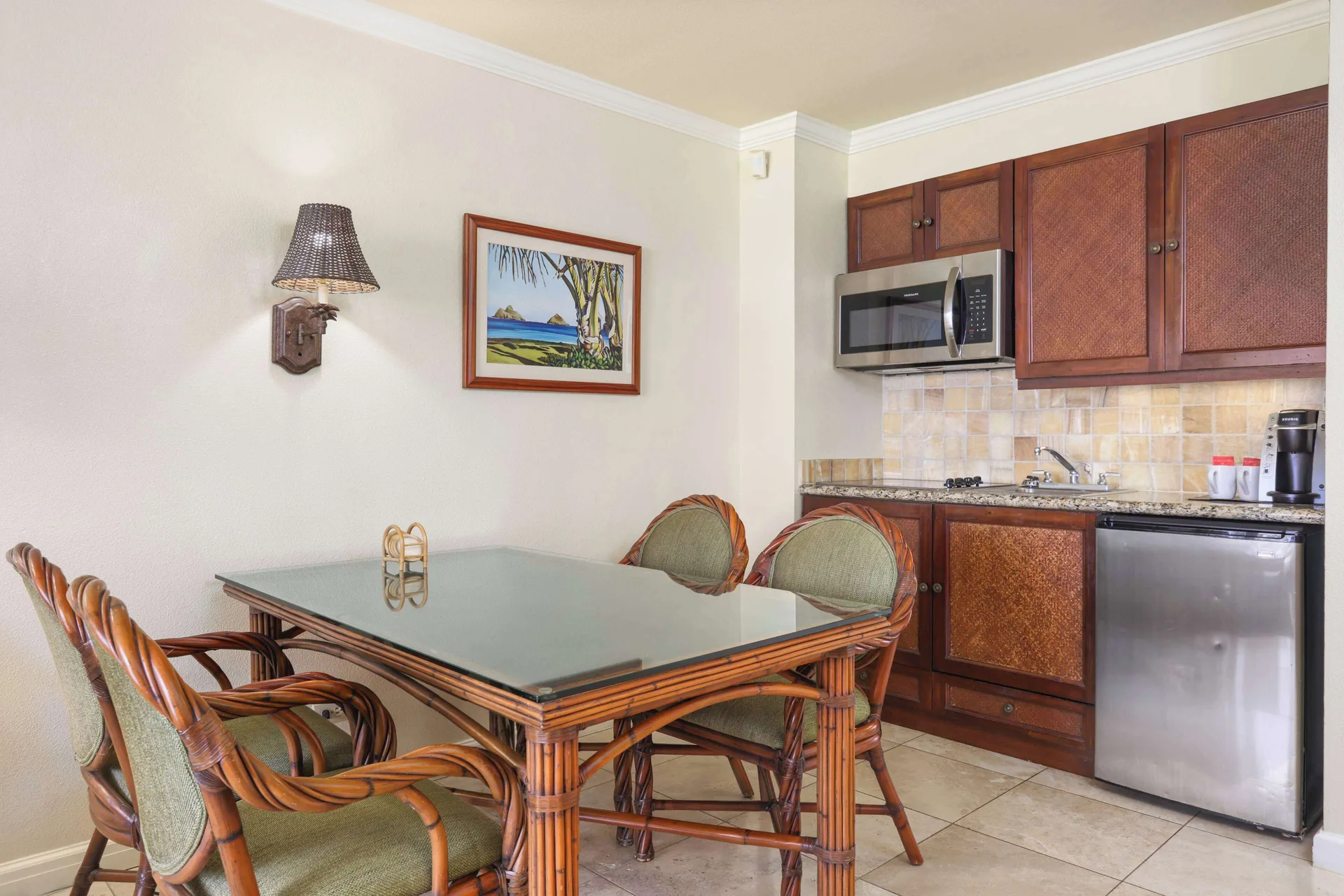 Kitchenette and dining table in a guest room at Aston Islander on the Beach.