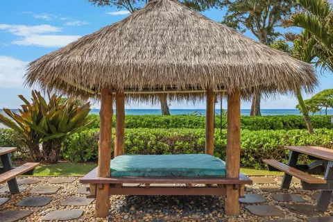 Thatched daybed facing the ocean at Aston Islander on the Beach.