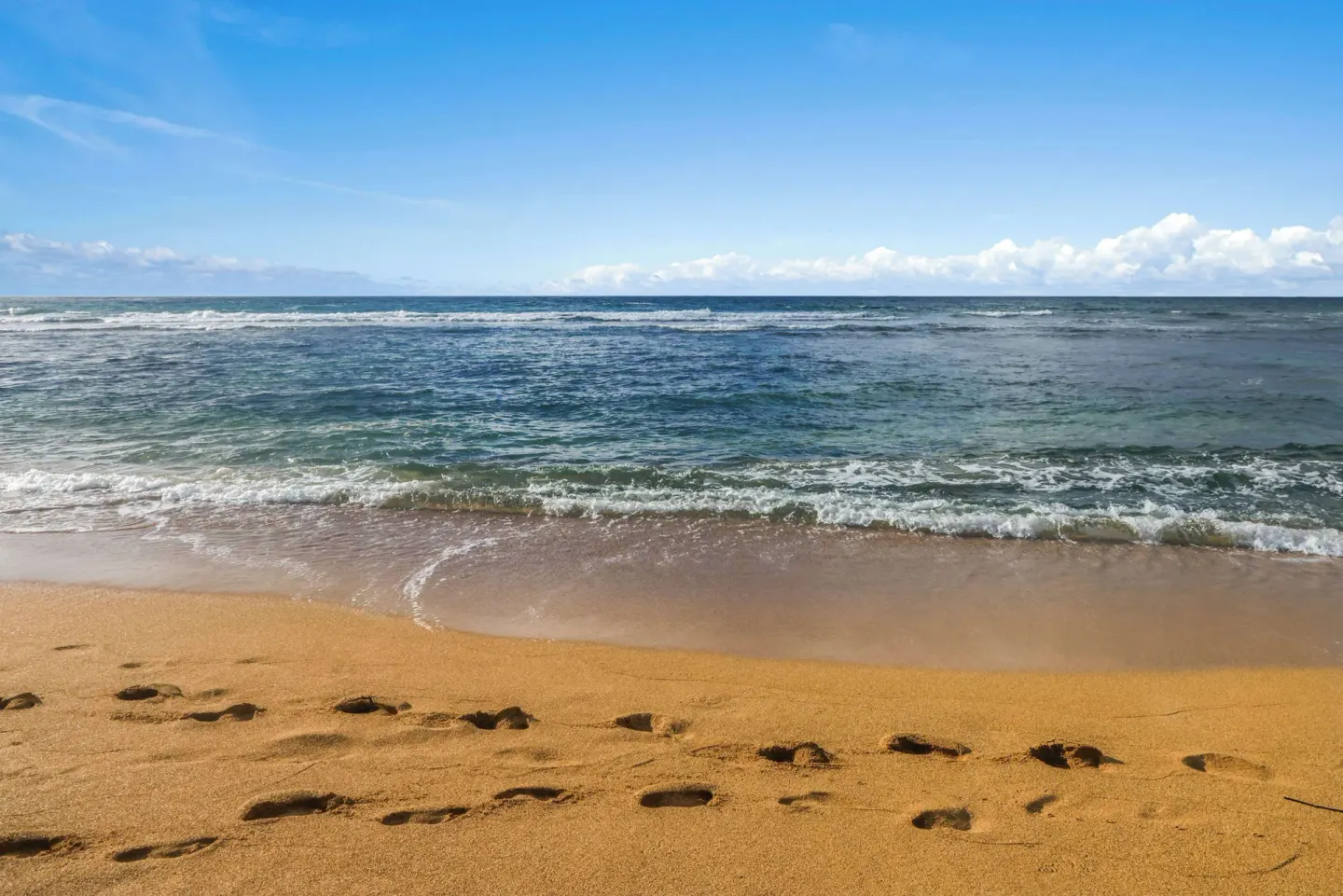 Footprints in sand by the ocean at Aston Islander on the Beach.