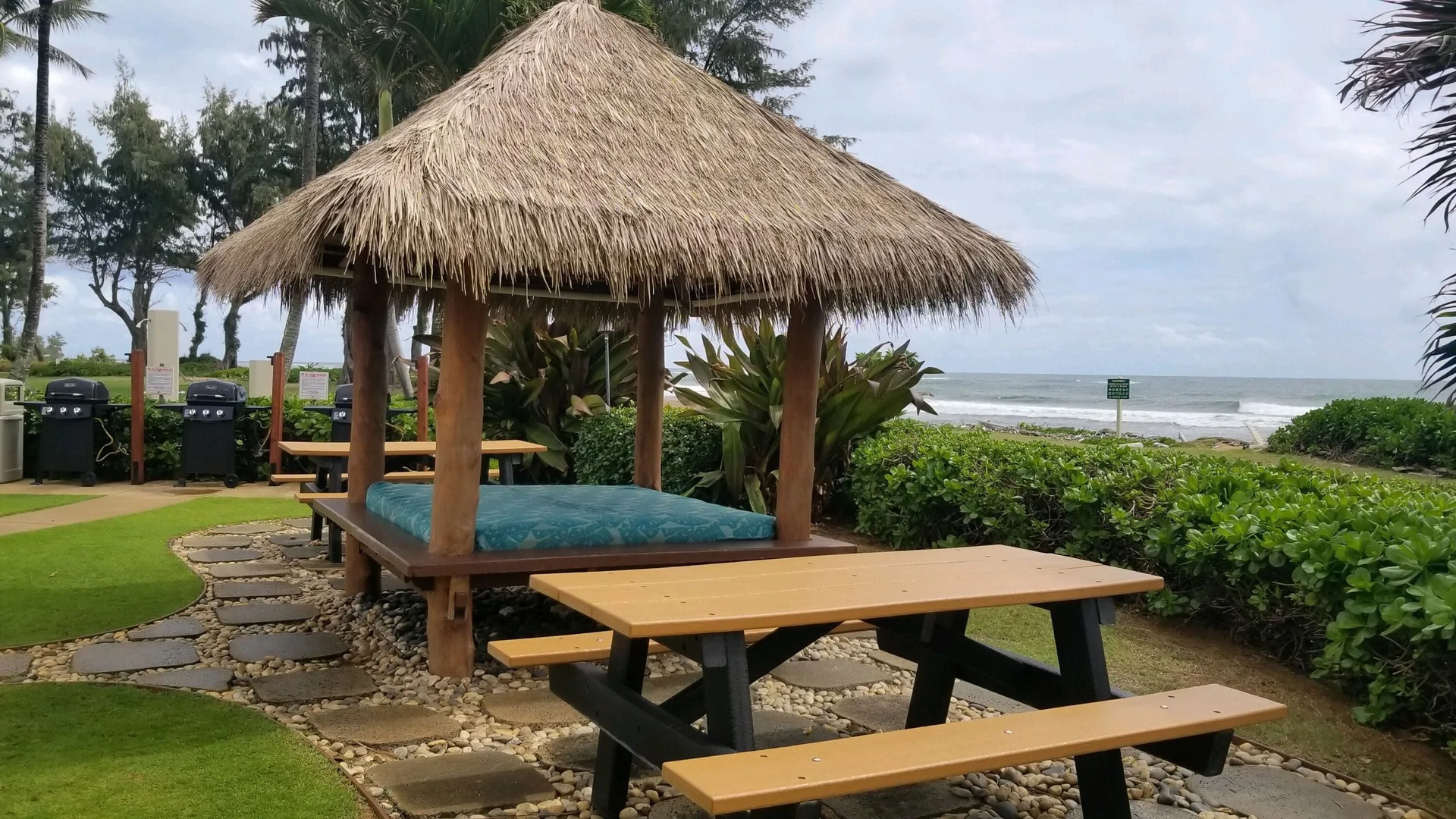 Thatched picnic pavilion by the ocean at Aston Islander on the Beach.