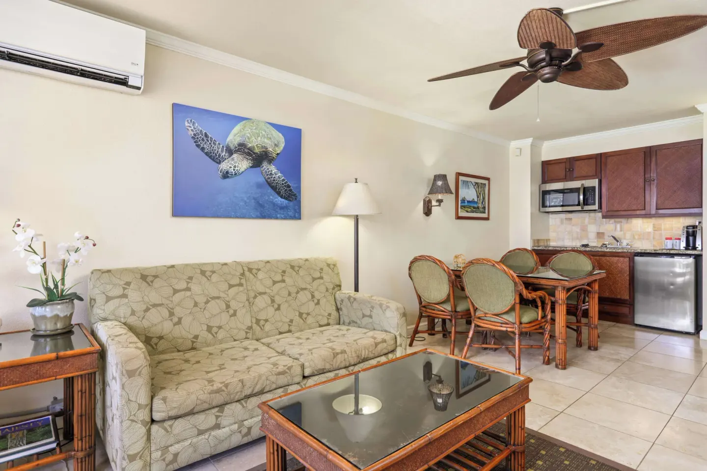 Panoramic Suite living area with sofa and kitchenette at Aston Islander on the Beach.