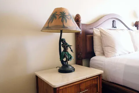 Garden View room bedside lamp and bed detail at Aston Islander on the Beach.