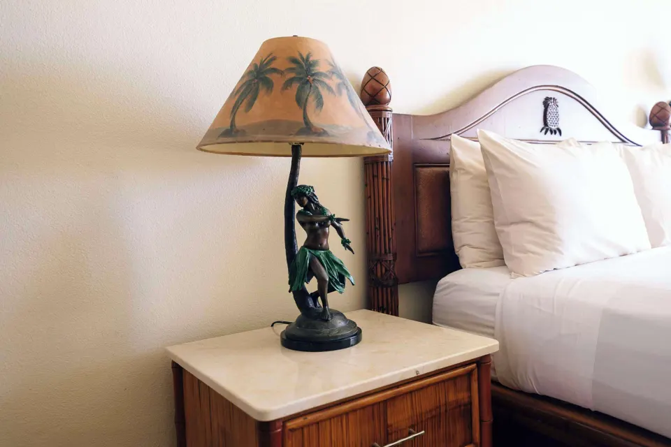 Garden View room bedside lamp and bed detail at Aston Islander on the Beach.