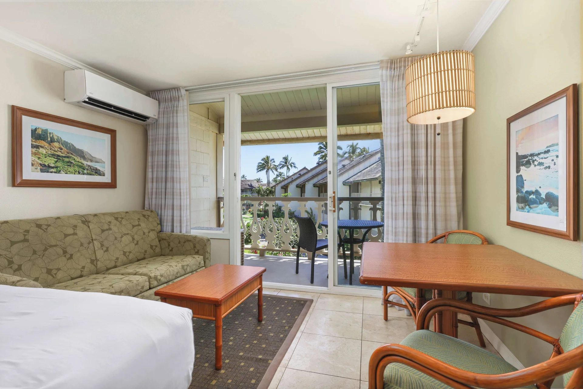 Ocean View room seating area with balcony doors at Aston Islander on the Beach.