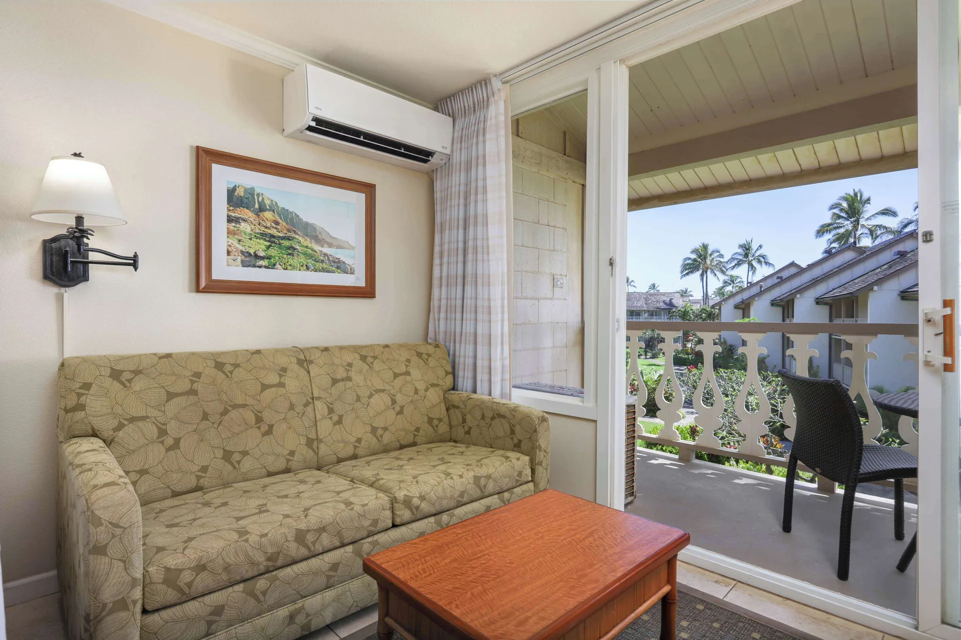 Ocean View room sofa beside balcony doors at Aston Islander on the Beach.