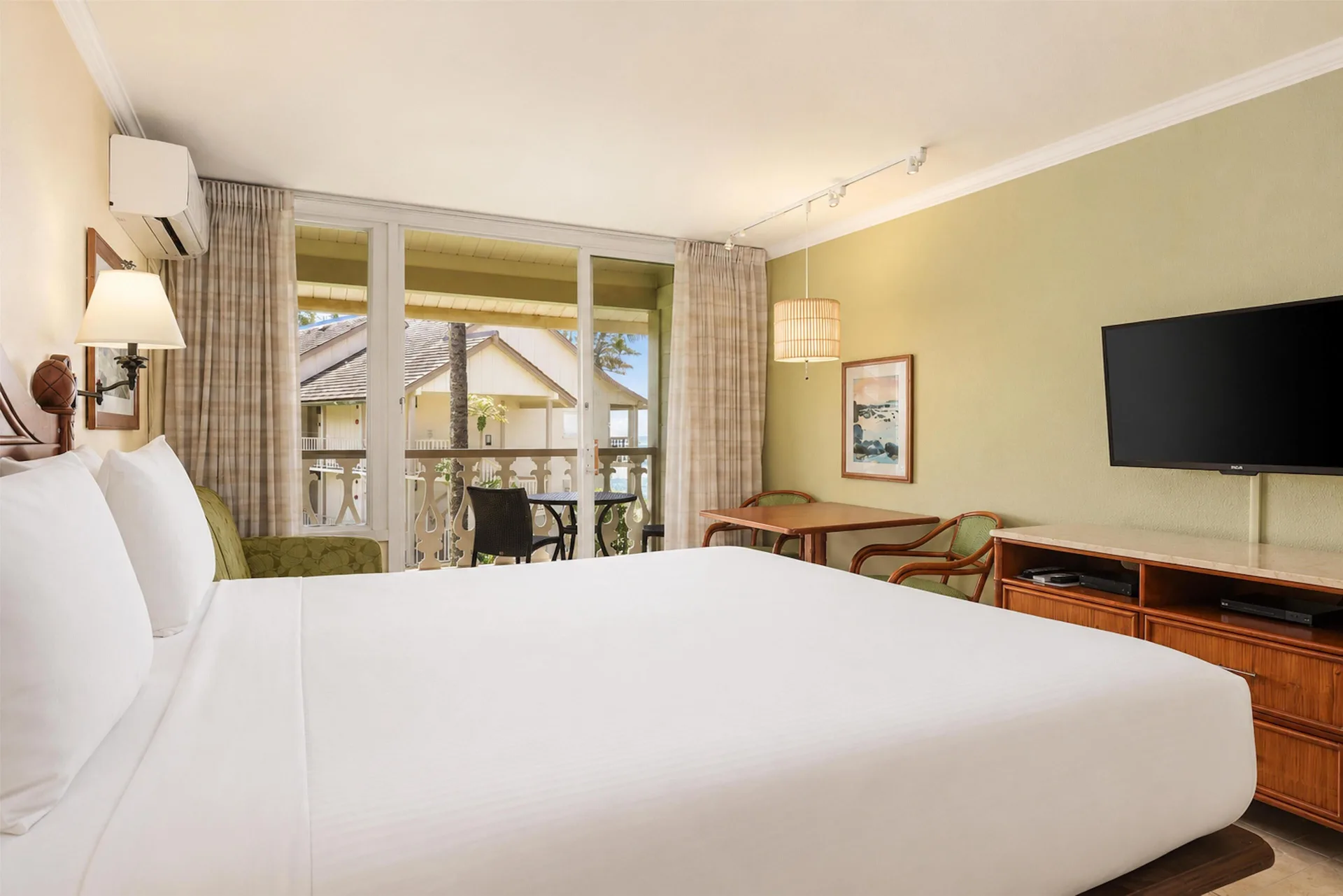 Ocean View room with king bed, balcony, desk, and TV at Aston Islander on the Beach.