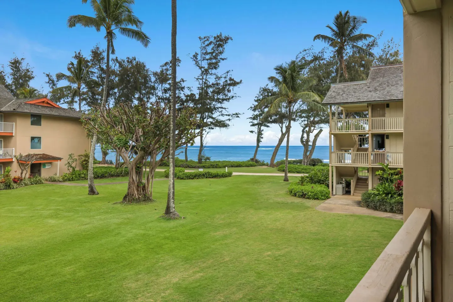 Partial ocean view over lawns and palm trees from Aston Islander on the Beach.