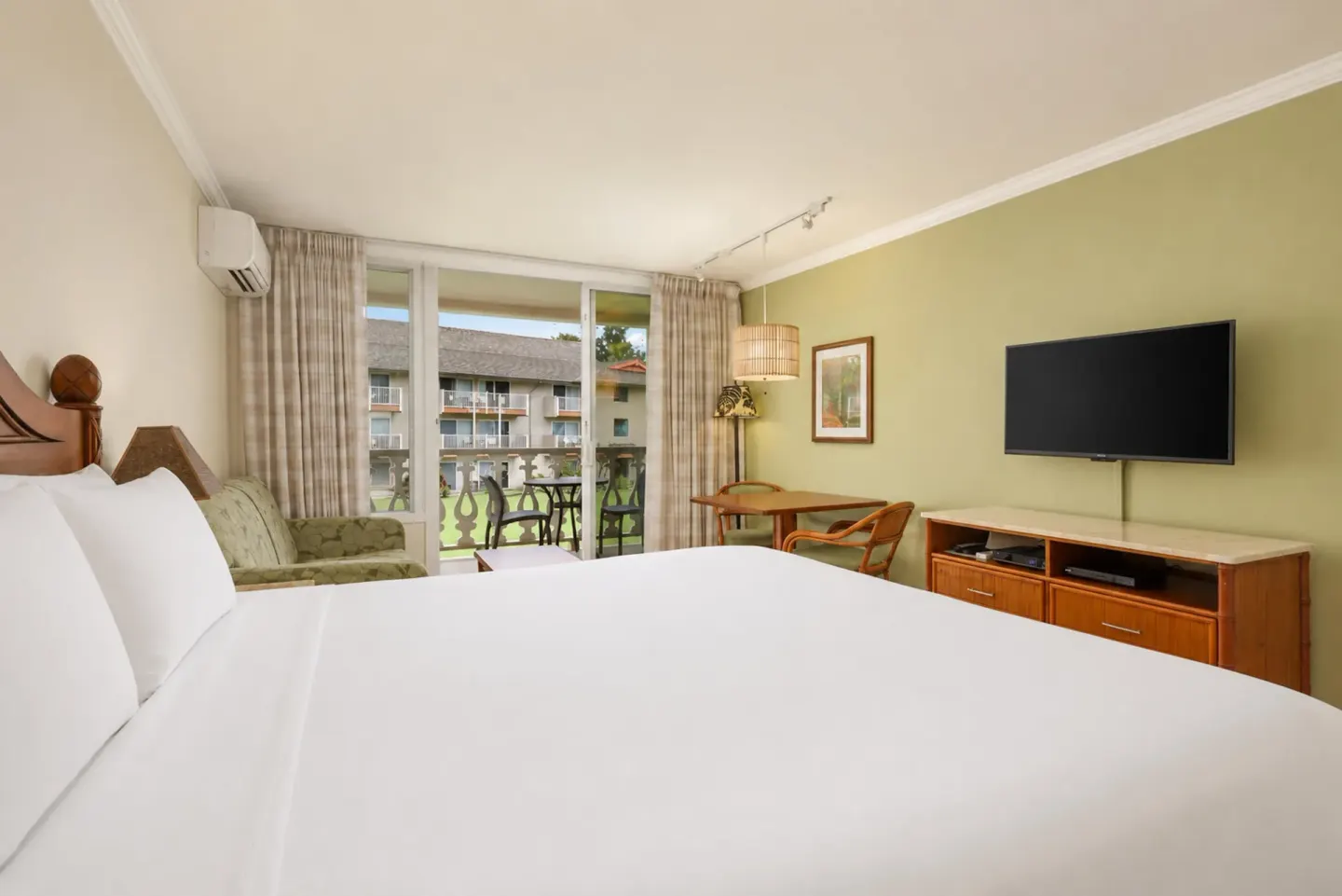 Partial Ocean View room with king bed and balcony at Aston Islander on the Beach.