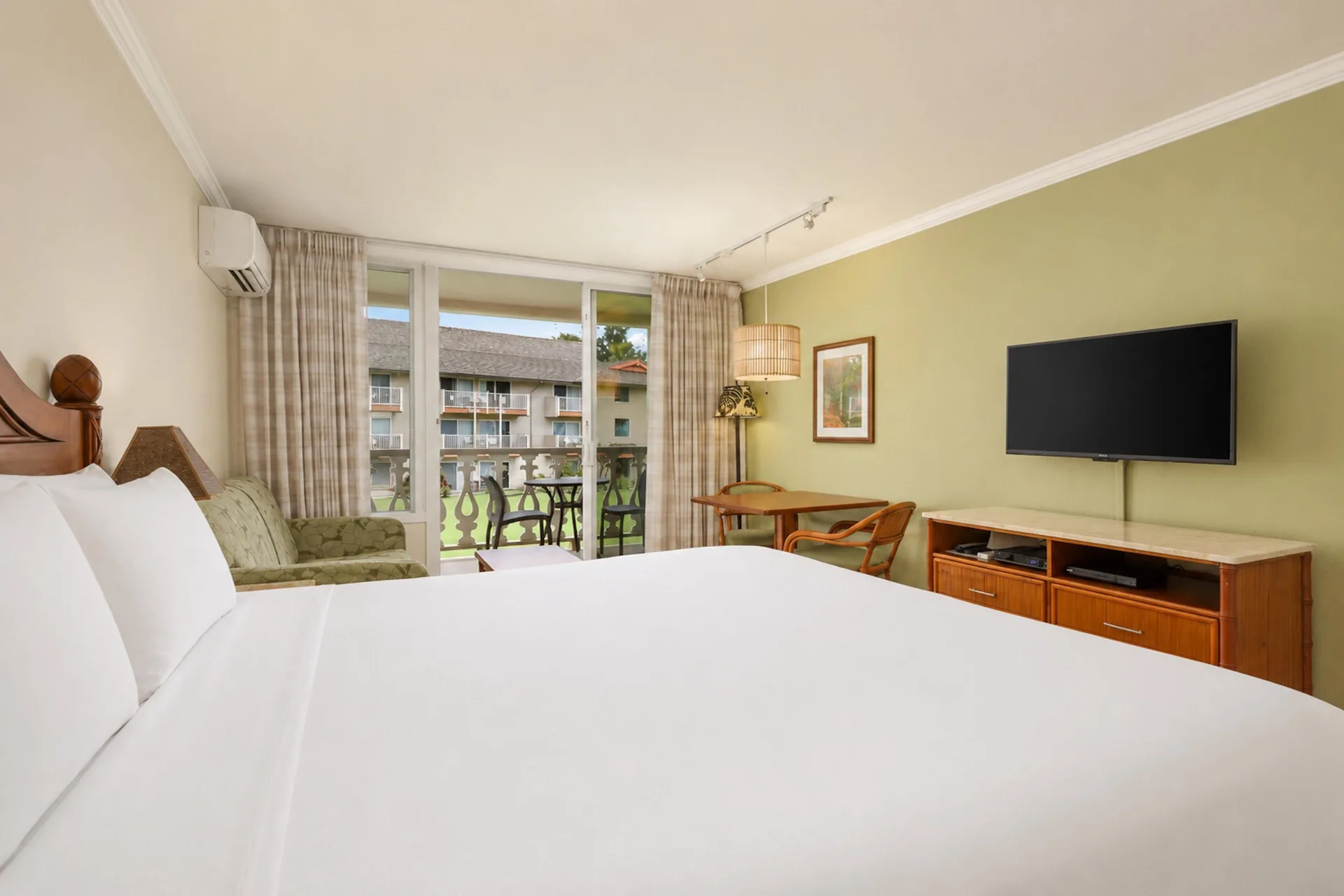 Partial Ocean View room with king bed and balcony at Aston Islander on the Beach.