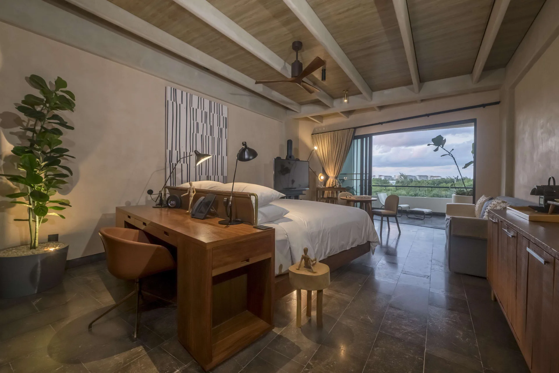 Inspira Junior Suite Ocean Front bed facing balcony at Atelier Playa Mujeres.