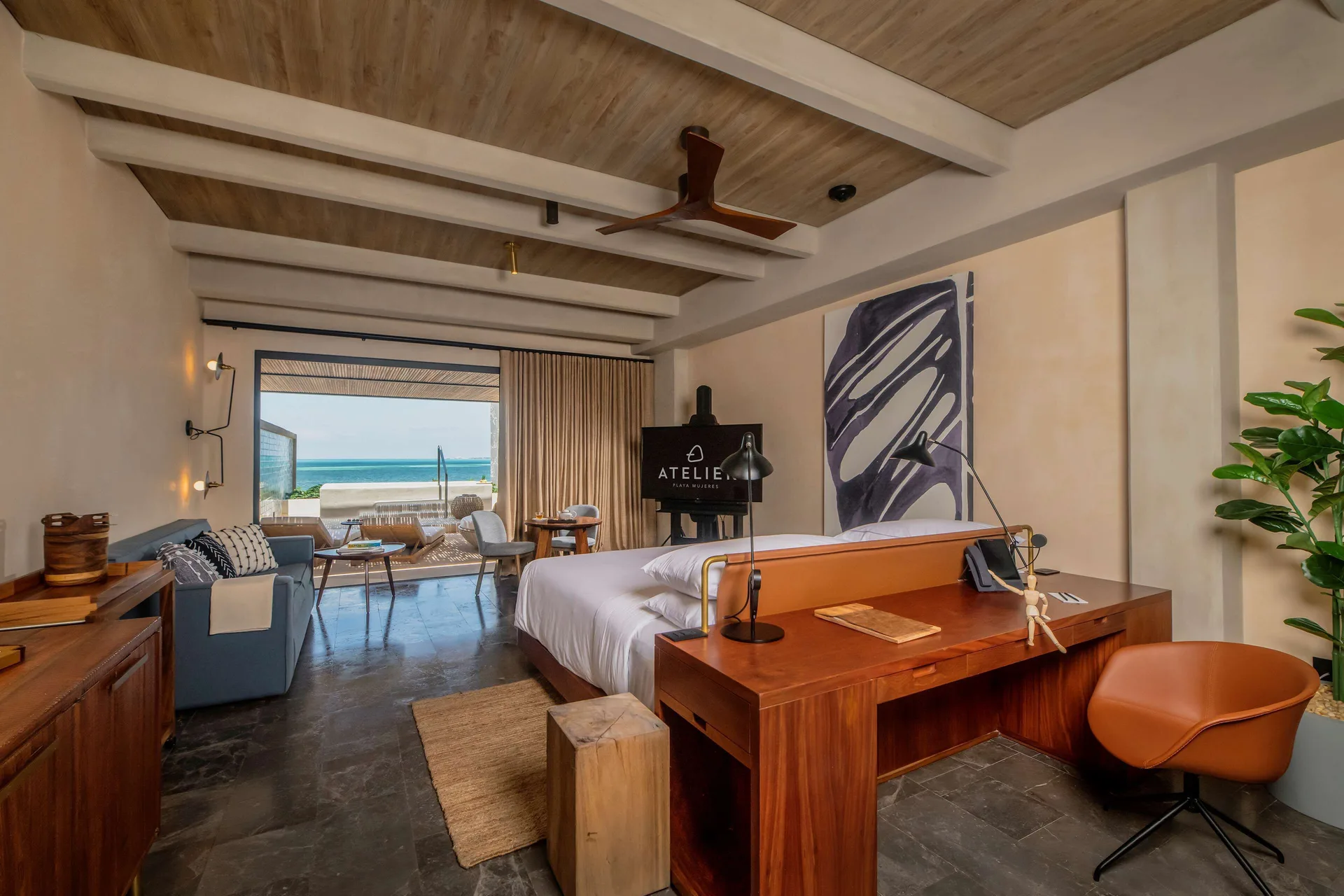 Inspira Junior Suite Ocean Front king bed with terrace and ocean beyond at Atelier Playa Mujeres.