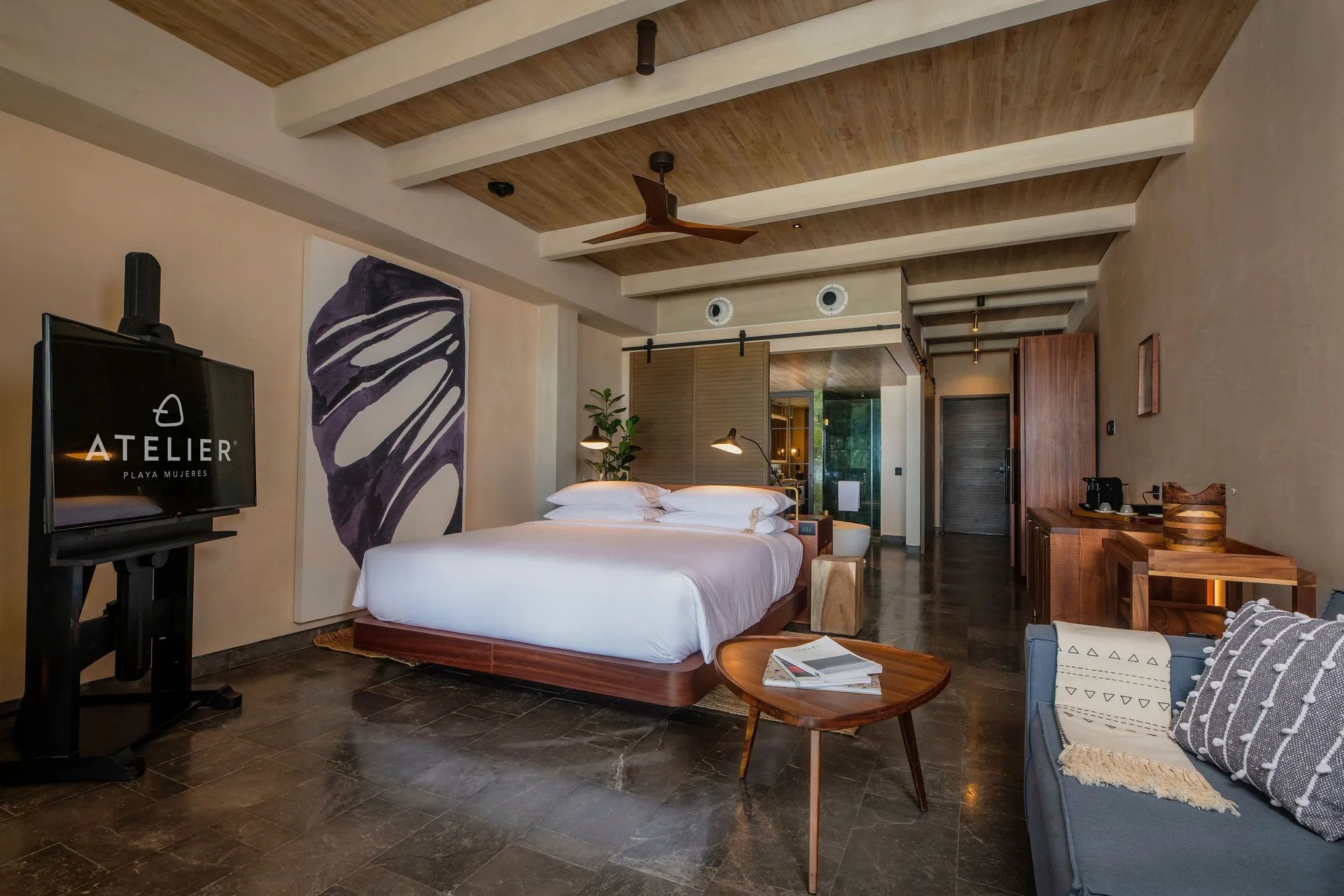 Inspira Junior Suite Ocean Front king bed and seating area at Atelier Playa Mujeres.