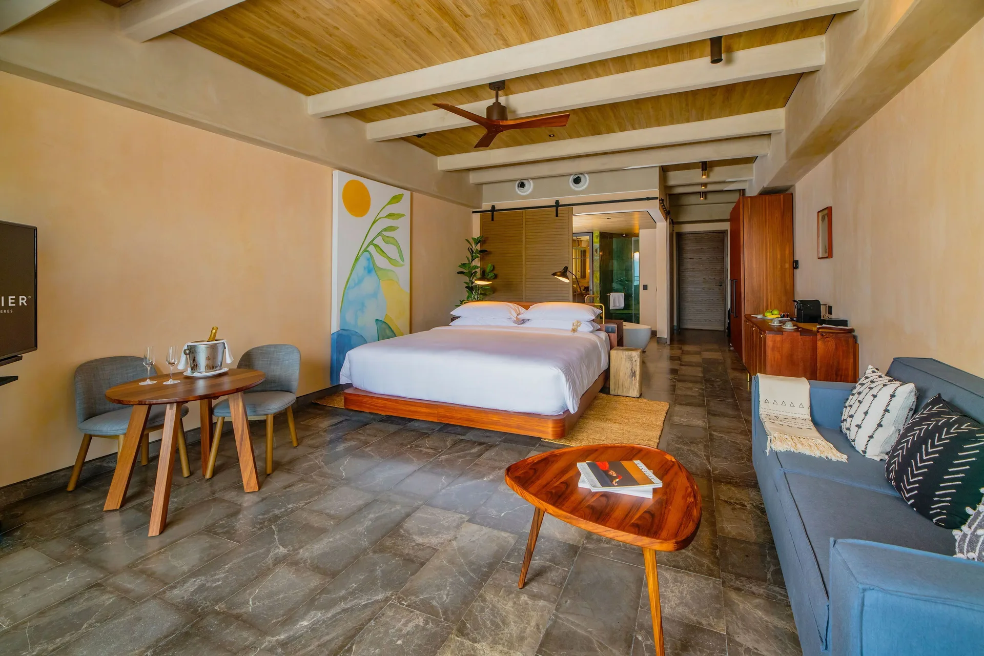 Inspira Junior Suite Swim Out Ocean View with king bed and dining table at Atelier Playa Mujeres.