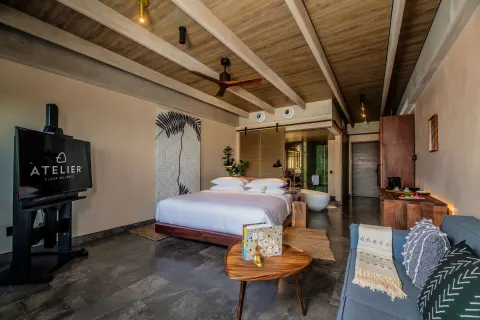 Inspira Junior Suite Swim Out Ocean View with king bed and sofa at Atelier Playa Mujeres.
