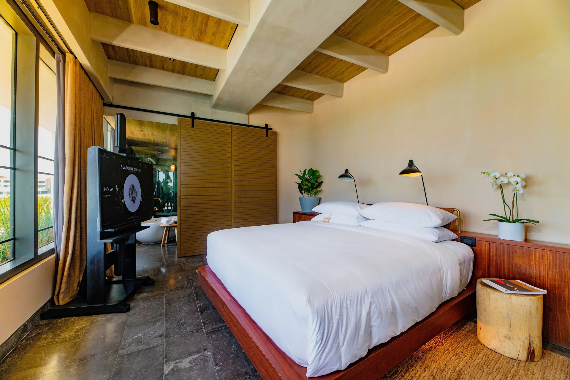 Inspira Master Suite Ocean Front bedroom with king bed at Atelier Playa Mujeres.