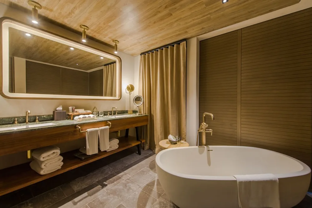 Bathroom with freestanding tub in a Junior Suite Ocean View at Atelier Playa Mujeres.