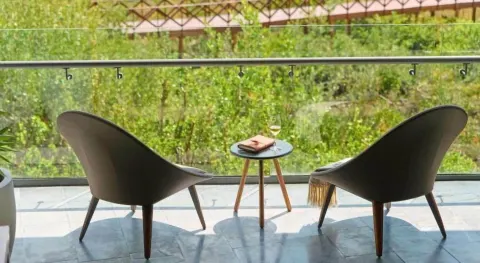 Junior Suite balcony chairs and small table at Atelier Playa Mujeres.