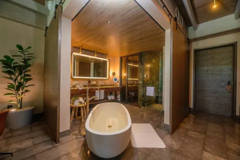 Junior Suite bathroom with soaking tub and vanity at Atelier Playa Mujeres.