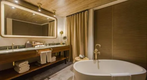 Junior Suite bathroom vanity and oval soaking tub at Atelier Playa Mujeres.