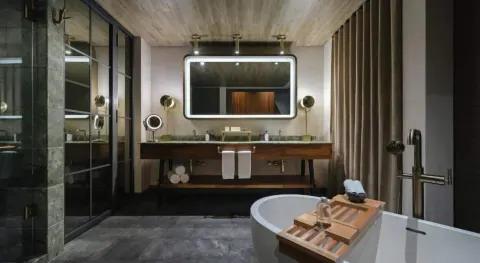 Junior Suite bathroom vanity and tub at Atelier Playa Mujeres.