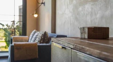 Junior Suite cabinet detail with sofa and balcony doors beyond at Atelier Playa Mujeres.