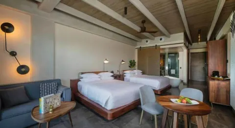 Junior Suite with two beds and sofa at Atelier Playa Mujeres.