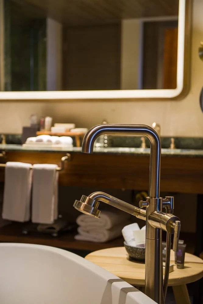 Bathtub faucet and vanity in a Wheelchair Accessible Junior Suite at Atelier Playa Mujeres.