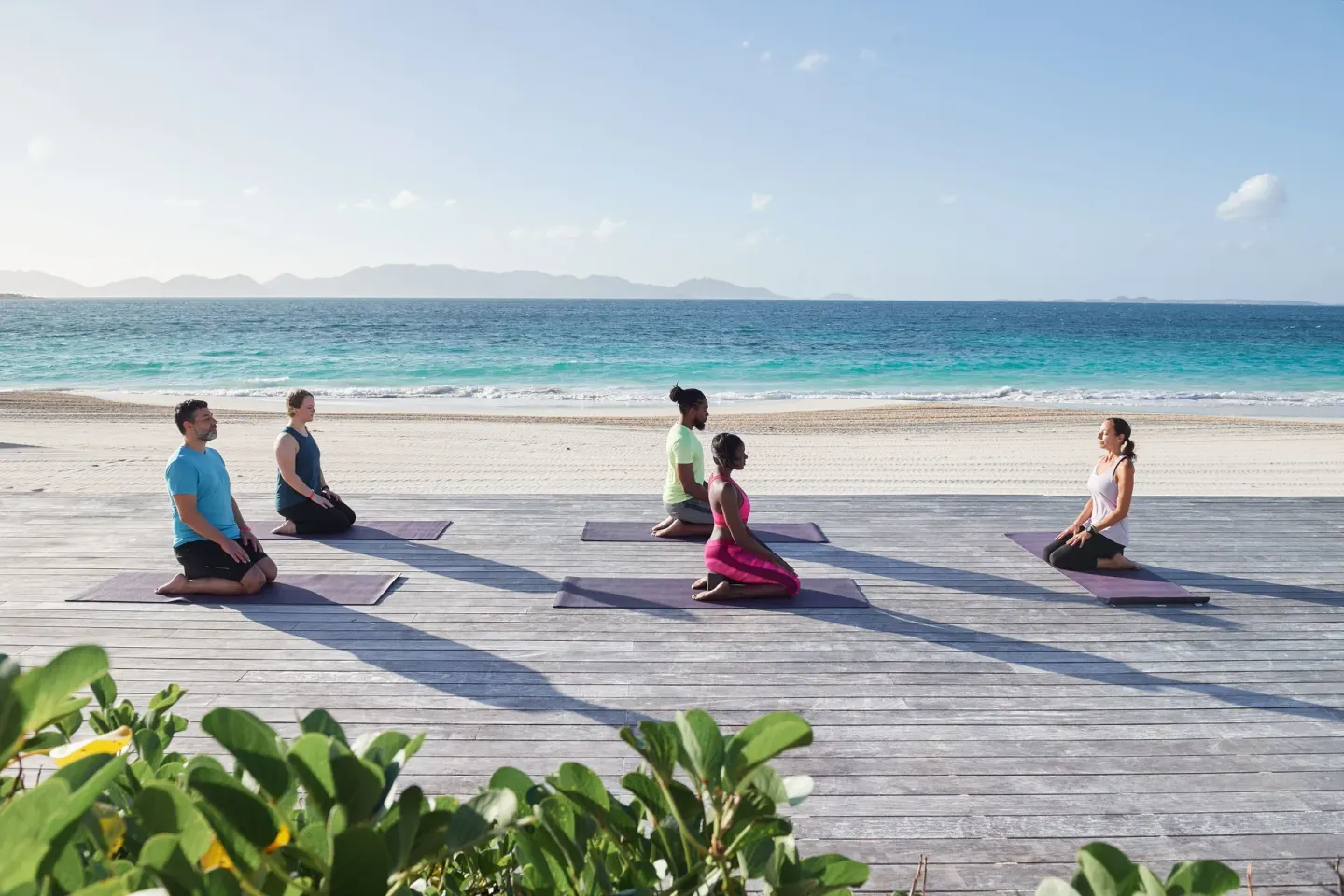 Yoga mats are arranged on a beachfront deck at Aurora Anguilla Resort & Golf Club.