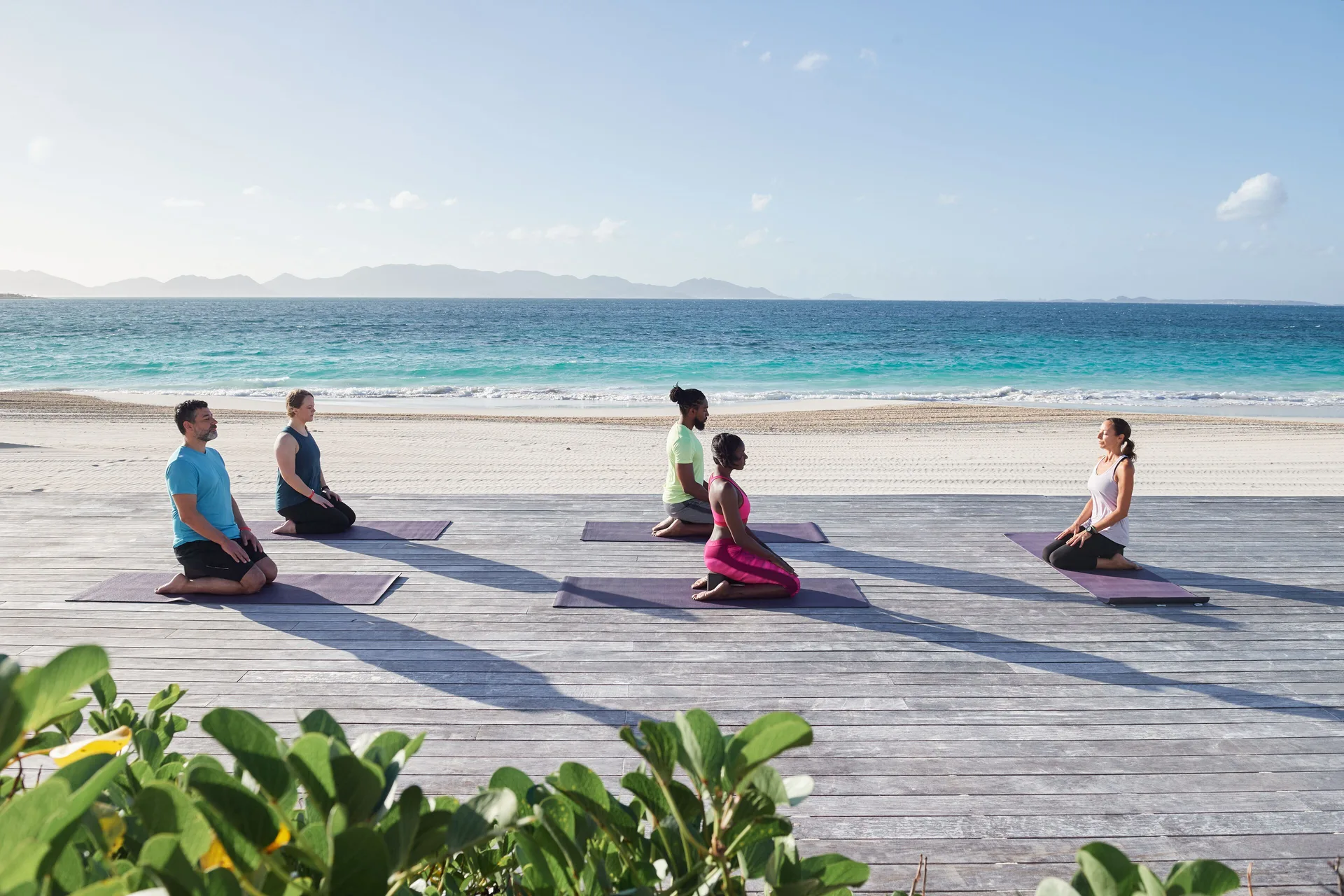 Yoga mats are arranged on a beachfront deck at Aurora Anguilla Resort & Golf Club.