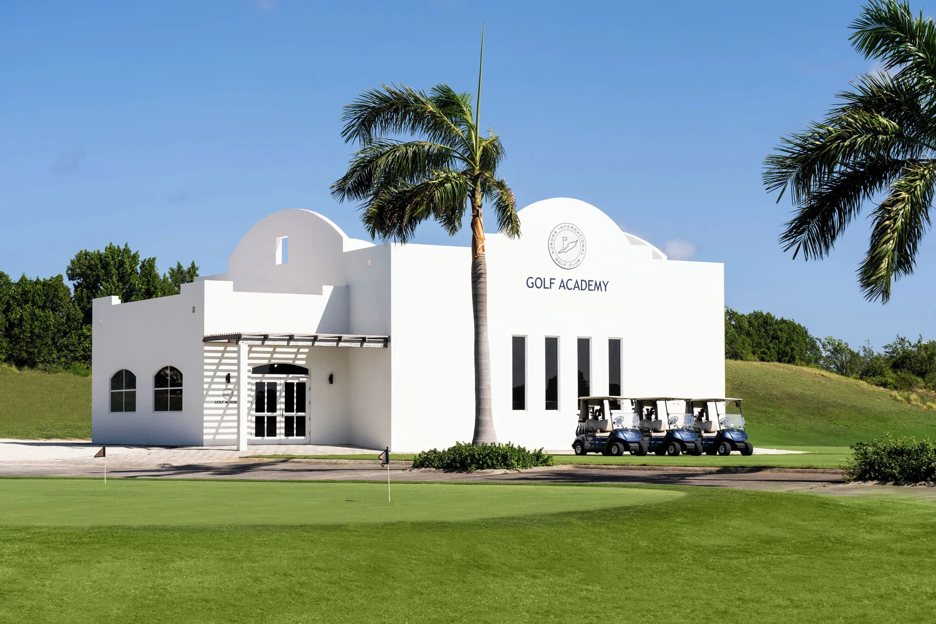 White Golf Academy building and golf carts at Aurora Anguilla Resort & Golf Club.