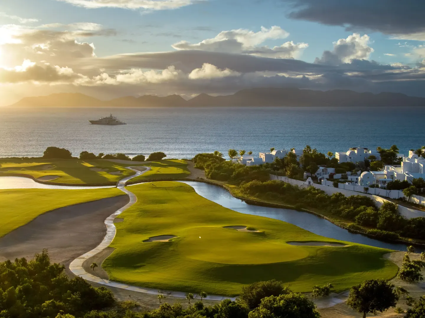 Sunset over the golf course and sea at Aurora Anguilla Resort & Golf Club.