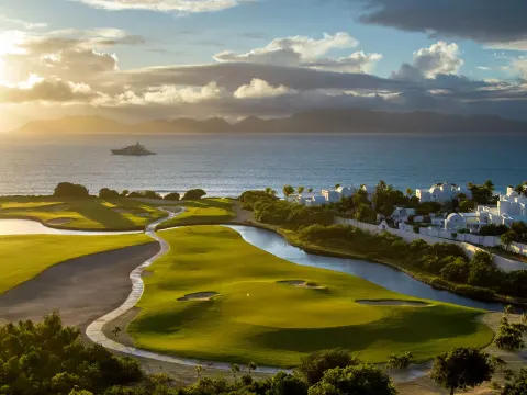 Sunset over the golf course and sea at Aurora Anguilla Resort & Golf Club.