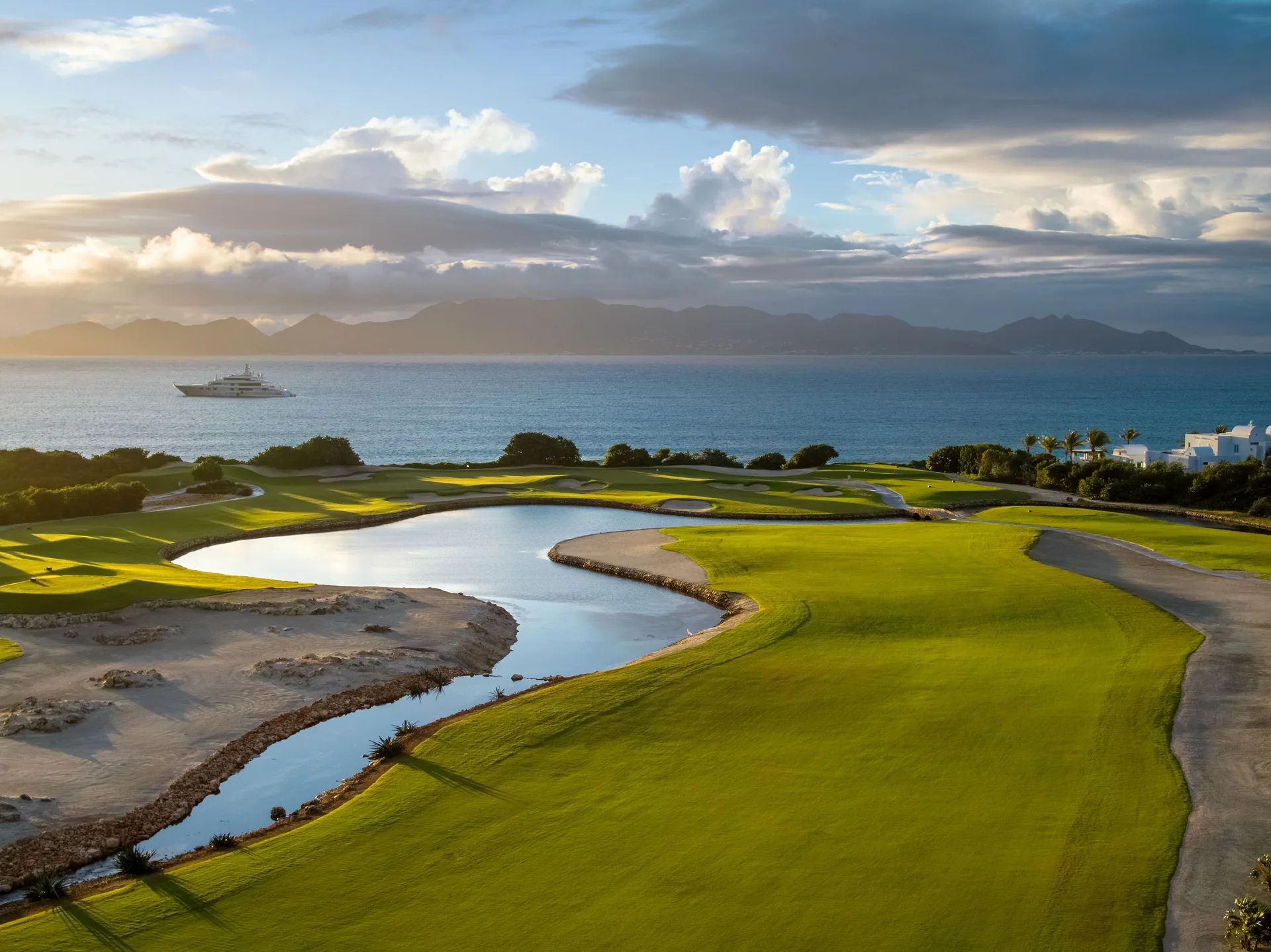 Sunlit golf course, lagoon, and sea view at Aurora Anguilla Resort & Golf Club.