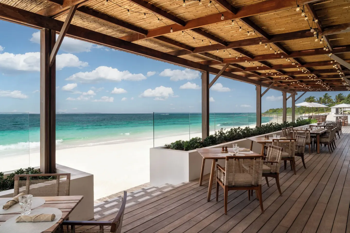 Beachfront dining terrace with ocean views at Aurora Anguilla Resort & Golf Club.