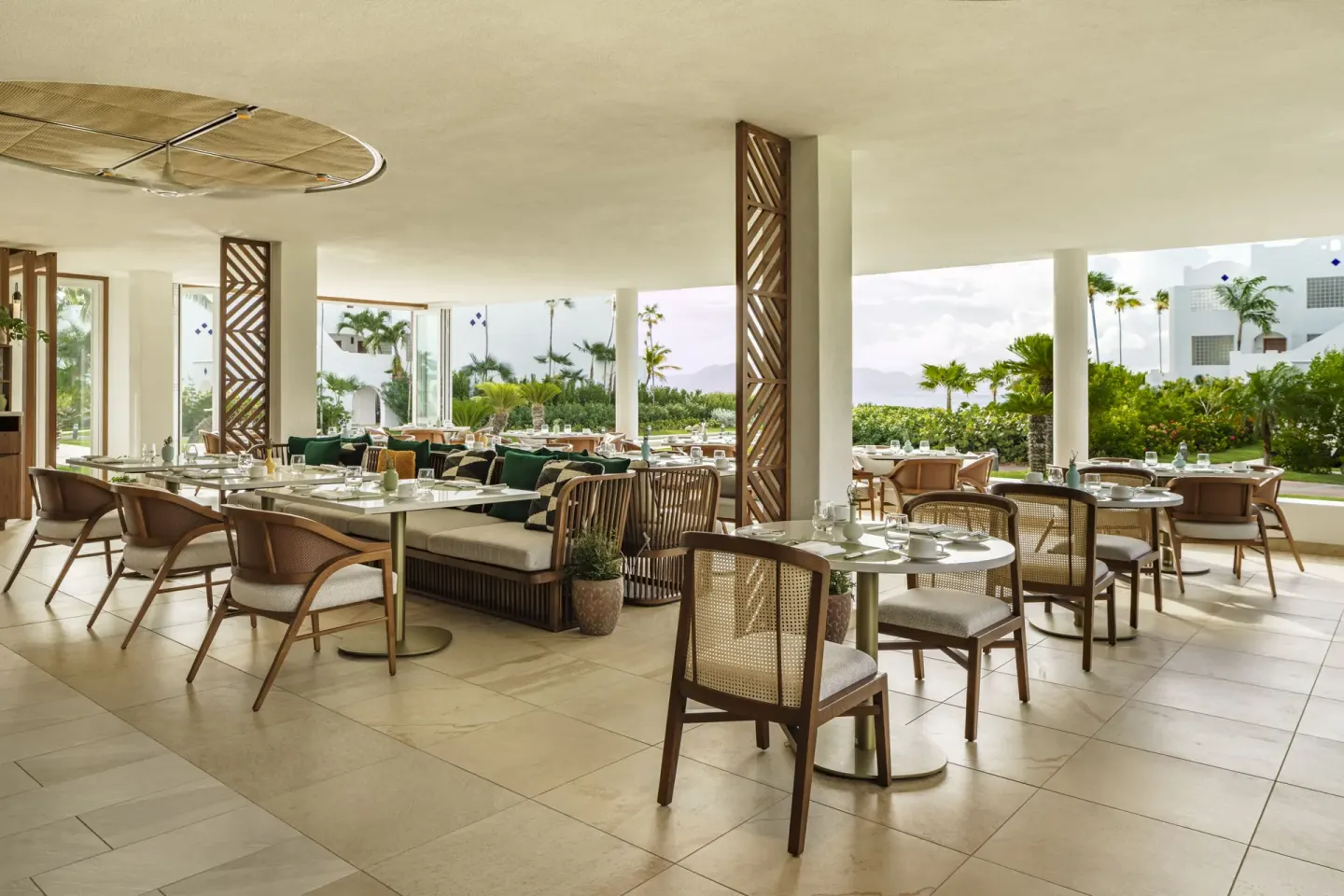 Open-air dining room with garden views at Aurora Anguilla Resort & Golf Club.