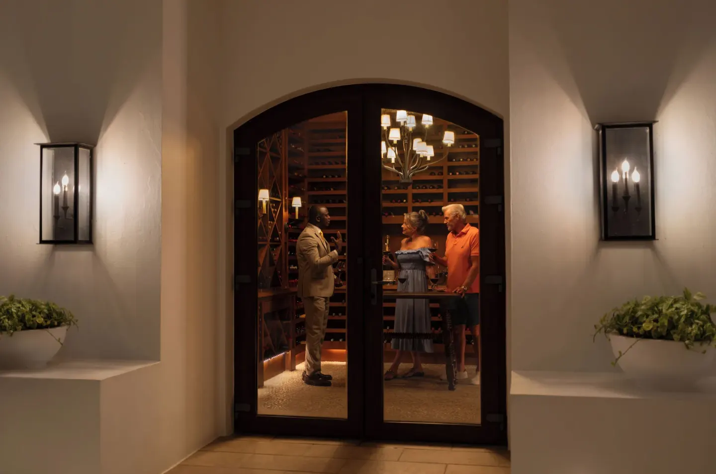 Guests inside a wine room entrance at Aurora Anguilla Resort & Golf Club.
