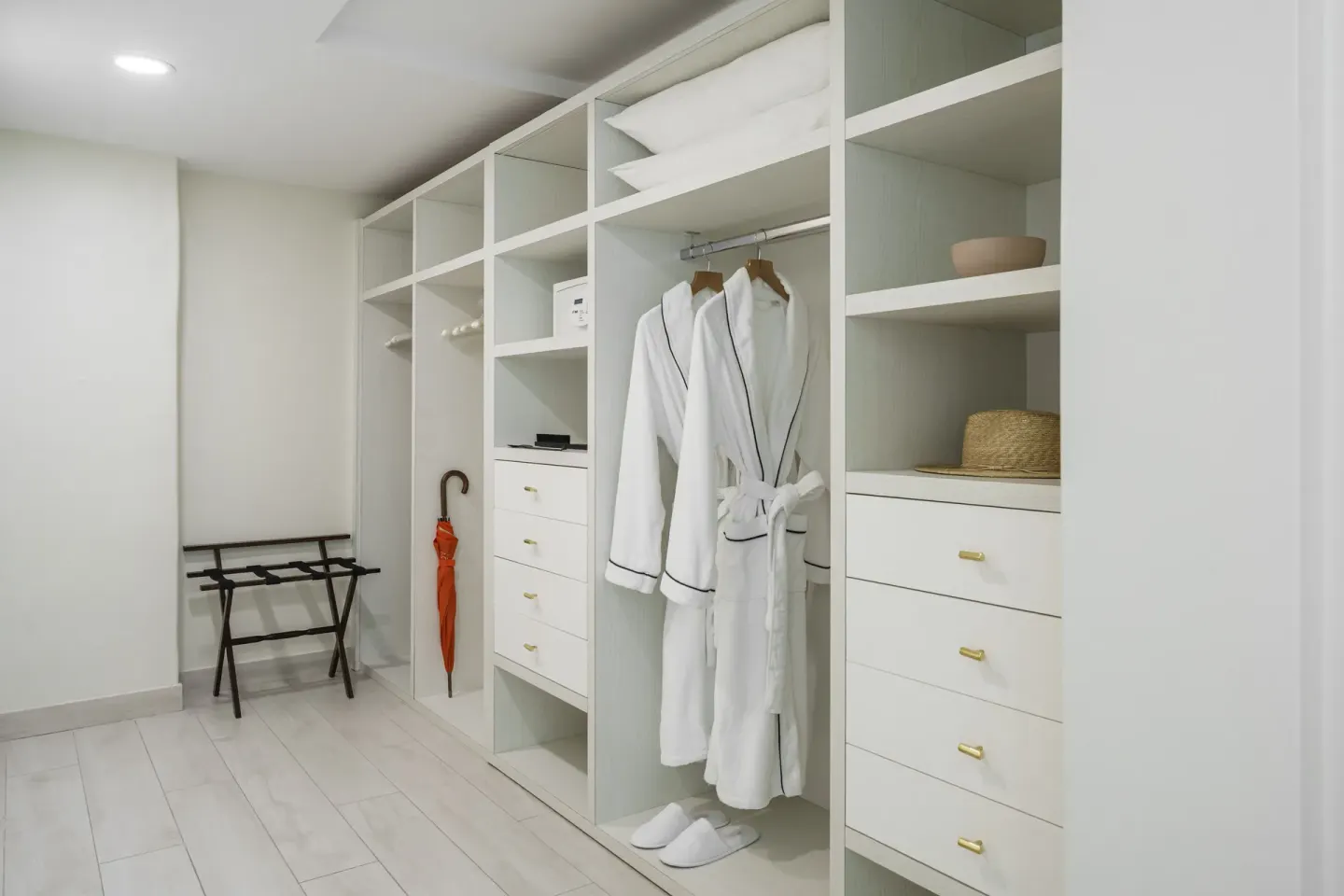 Walk-in closet with robes and drawers in a Beachfront Junior Suite at Aurora Anguilla Resort & Golf Club.