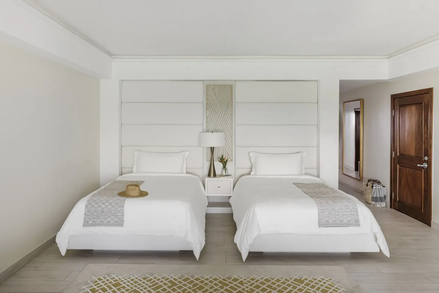 Two beds in a Beachfront Junior Suite Rendezvous Beach at Aurora Anguilla Resort & Golf Club.