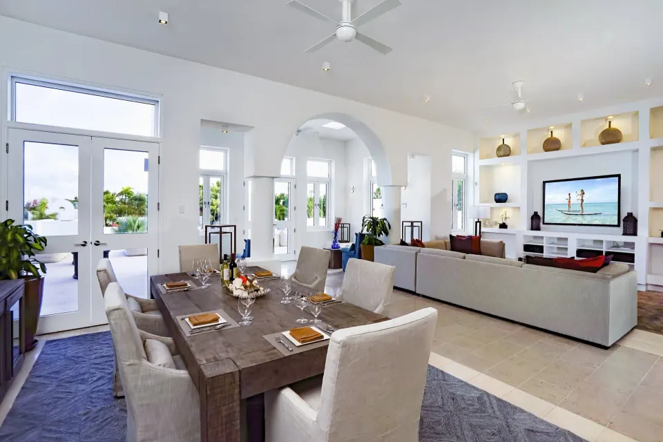 Dining and living room in the Five Bedroom Estate Home at Aurora Anguilla Resort & Golf Club.