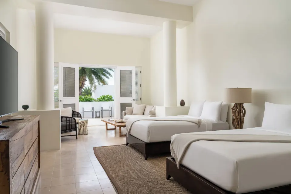 Two queen beds in the Five Bedroom Estate Home at Aurora Anguilla Resort & Golf Club.