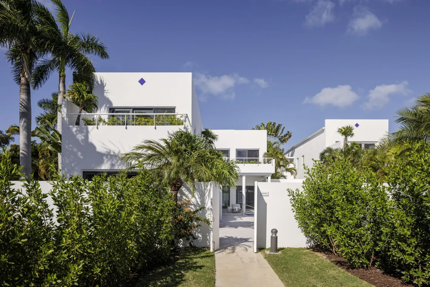 Five Bedroom Garden Villa exterior with palms at Aurora Anguilla Resort & Golf Club.