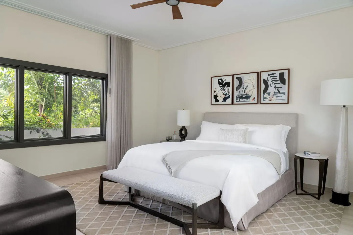 Five Bedroom Garden Villa king bedroom with garden-facing windows at Aurora Anguilla Resort & Golf Club.
