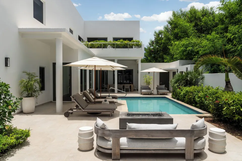 Garden villa pool terrace with loungers and umbrellas at Aurora Anguilla Resort & Golf Club.