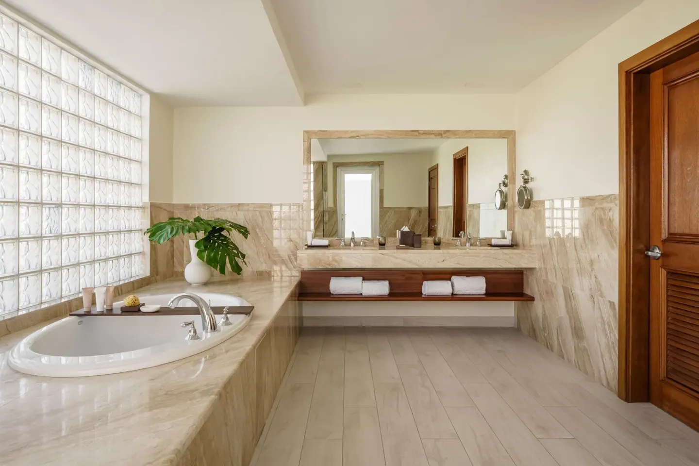 Island View Deluxe Room marble bathroom with oval tub at Aurora Anguilla Resort & Golf Club.