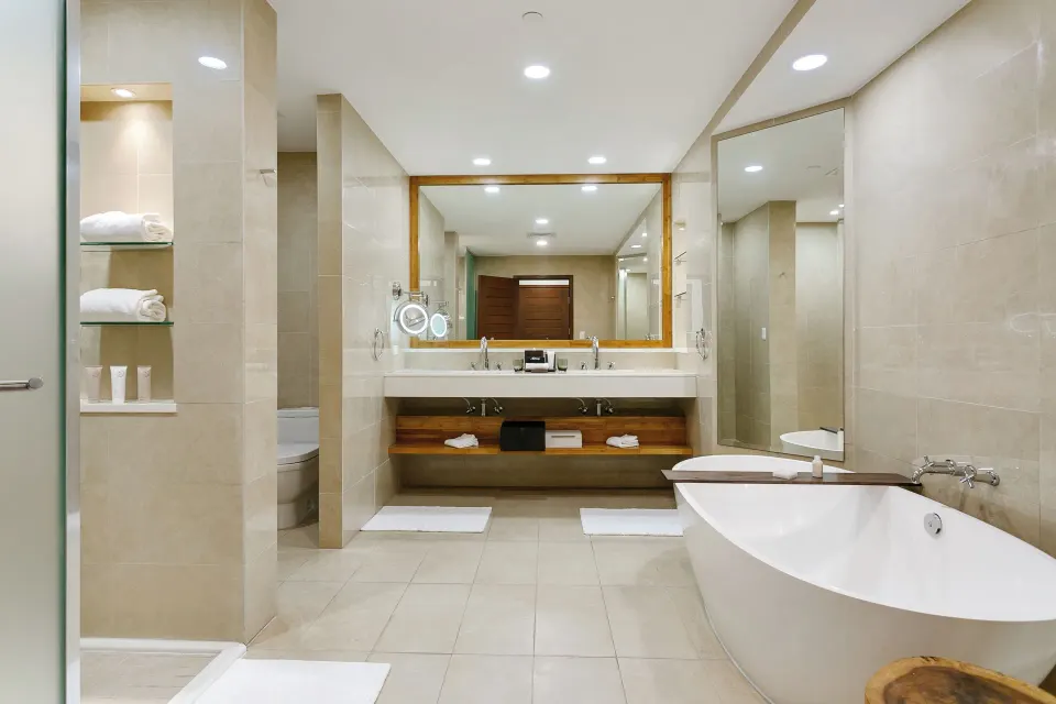 Island View Deluxe Room bathroom vanity and tub at Aurora Anguilla Resort & Golf Club.