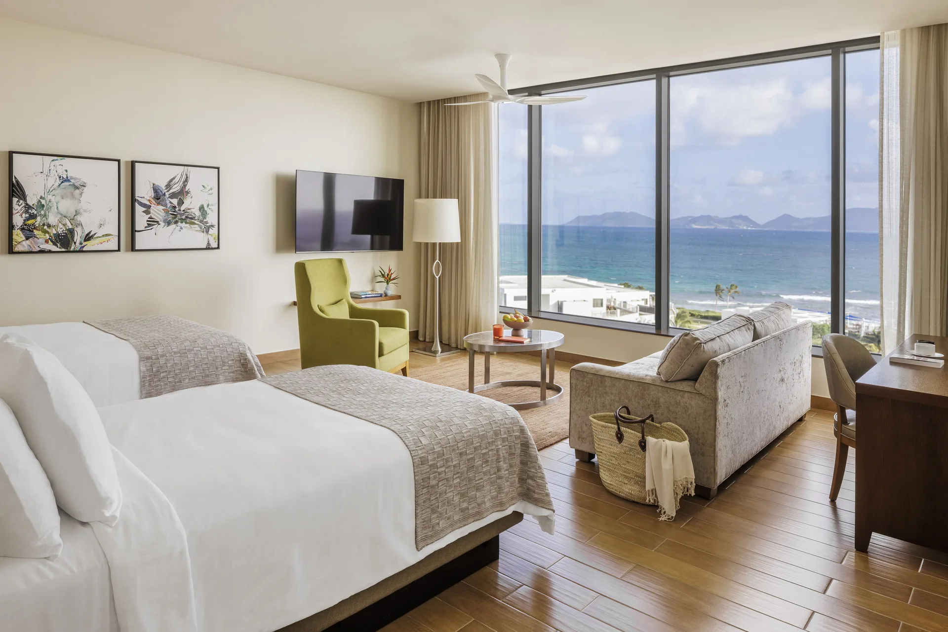Oceanfront Junior Suite with king bed and sea view at Aurora Anguilla Resort & Golf Club.