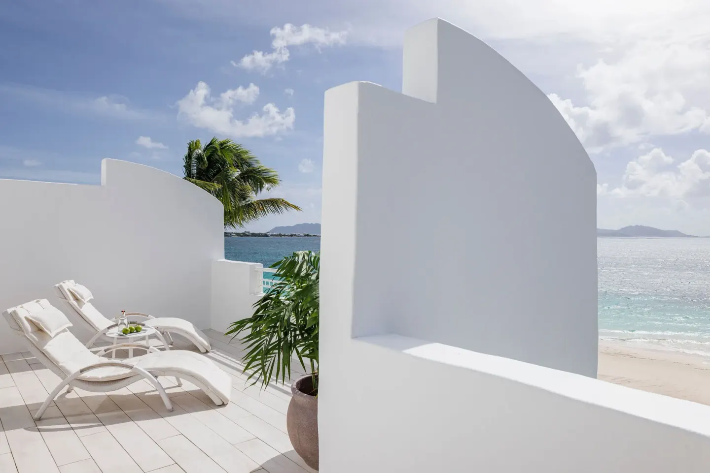 Private oceanfront terrace with loungers at Aurora Anguilla Resort & Golf Club.